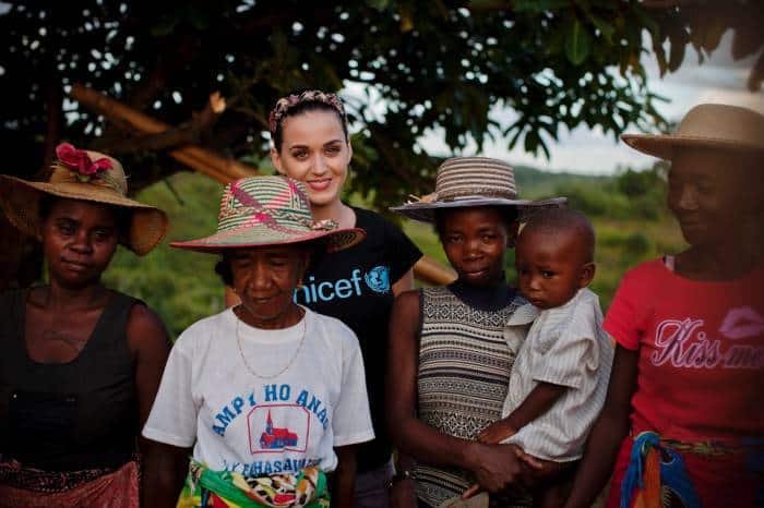 Katy Perry poses for a photograph with women wearing beautiful hats. Kate Holt.