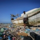 Haziz, an economic migrant from Ethiopia's Ogaden region, stands next to a boat. Kate Holt.