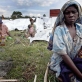 Wimana Ruhuwreru holds her son Emmanuel where they sleep in the open air. Kate Holt.