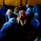 A young woman listens to a Health education talk at Woch Tangai Health Center. Kate Holt.