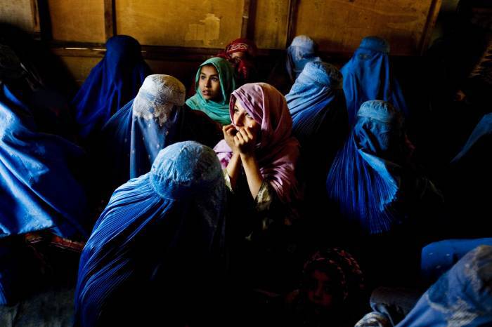 A young woman listens to a Health education talk at Woch Tangai Health Center. Kate Holt.