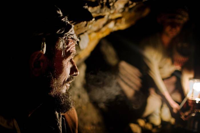 Azrat Mohammed looks passed a colleague while in a tunnel. Kate Holt.