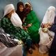 Women in the burkas look at a newborn baby in the maternity unit at the Provincial Hospital. Kate Holt.