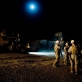 Lt Bales of 2/2 US Marines briefs his troops beneath a full moon before carrying out a night patrol. Kate Holt.
