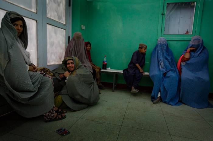 Burka clad women and their children sit in the waiting room of Mirwais Hospital. Kate Holt.