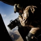 An ISAF (International Securitisation Assistance Force) gunner keeps watch out the side of a helicopter. Kate Holt.
