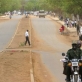 Two men ride on a motorbike drive down a newly tarmaced road in Juba. Kate Holt.