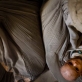 A mother cradles her malnourished child in her lap at a feeding centre that is supported by UNICEF. Kate Holt.