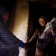 Sadiqa hold her baby Soraya, and shakes hands with Sadiqa Hosseini. Kate Holt.