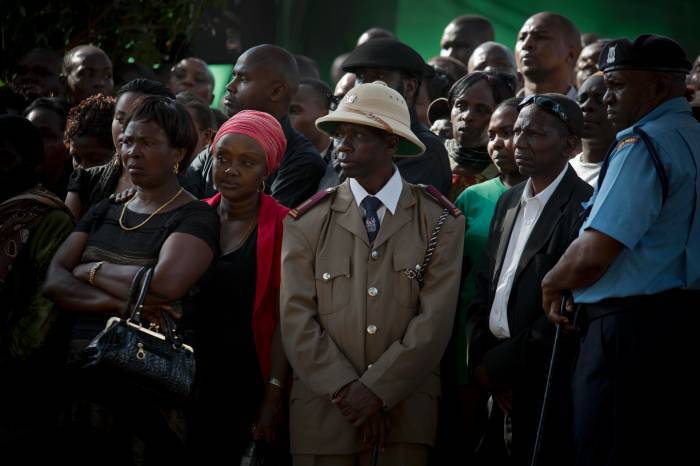Mourners gather at the burial of President Kenyatta's nephew. Kate Holt.