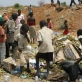 Young children hunt through a rubbish dump for food at a dumping site twelve miles outside of Juba. Kate Holt.