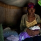A woman holds her newborn baby at her home in the village of Androranga Vola in Madagascar. Kate Holt.