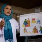 Community midwife, Sadiqa Hosseini, holds up an educational picture book. Kate Holt.