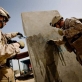 1st Lt Conner Gentil of 2/2 of the US Marine (R) and one of his soldiers washes off newly painted graffiti. Kate Holt.
