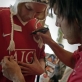 Carlos Tevez from Manchester United, signs the shirt of a young fan. Kate Holt.