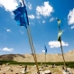 Flags blow in the wind at a graveyard near to the village of Foladia near Bamyan, Afghanistan. Kate Holt.