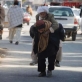 A man carries an elderly man on his back to the Emergency Unit of Bost Hospital. Kate Holt.