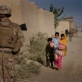 Young children walk down a street that is being patrolled by US Marines in Garmsir. Kate Holt.