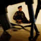 An Afghan Government Soldier sits guard outside of the office of the District Governor in Arghandab. Kate Holt.