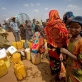 Newly arrived refugees from Somalia collect water at a water point. Kate Holt.
