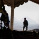 An Afghan Police Officer stands guard at a religious monument while taking part in a joint foot patrol. Kate Holt.