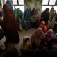 Children wait with their mothers to receive a vaccination in Bost Hospital. Kate Holt.