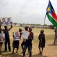 Street children hold photograph of the late Dr John Garang during a celebration of World Children's Day. Kate Holt.