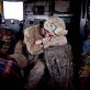 A US marine, who has been mentoring the training of Afghan National Army Soldiers sleeps on his rucksack in a helicopter. Kate Holt.