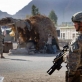 A soldier from the 82nd Airborne Division of the US army pass by the passes by a market stall. Kate Holt.