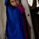 The neice of Sedamin poses for a photograph in her family's tent that is their home. Kate Holt.