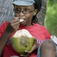 Gladys Luvuno Ndegwa an Earthwatch volunteer from Kenya enjoys eating a fresh coconut. Kate Holt.