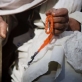 A man fingers his prayer beads outside the OPD unit of Bost Hospital in Lashkar Gah. Kate Holt.