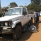 A car runs over a motorcycle at the Mobil Junction in Juba, Southern Sudan. Kate Holt.
