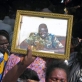 A family member holds up a photograph of Officer Abut who was killed in Yambio while on duty. Kate Holt.