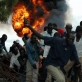 People run for safety as barrels of petrol explode in a market square in Juba. Kate Holt.
