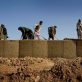 Locally employed workmen help to build an administrative base that is being secured by 2-508 of the 82nd Airborne Division. Kate Holt.