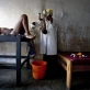A nurse delivers Chance's baby over a bucket in a poorly equipped health center. Kate Holt.