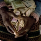 Masiziba Saiba is sits in her room with her life savings of Zimbabwean dollars that are now worthless. Kate Holt.