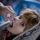 A young girl receives a polio vaccination as part of a 3 day nation wide vaccination campaign. Kate Holt.