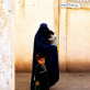 A widow from Afghanistan waits for help outside a medical center in a refugee camp in Pakistan. Kate Holt.