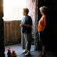 Two women return to what remains of their apartment building ten years since the war ended in Bosnia. Kate Holt.