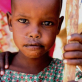 A young girl who lives in a community that is dependent on food aid supplied by Care. Kate Holt.