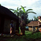 A family stand outside their homes in a small village north of Goma. Kate Holt.