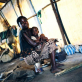 A young mother with her daughter in a tent they share with ten other families in the IDP camp. Kate Holt.