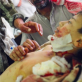 A father cries beside the bed of his son, caught in a cluster bomb explosion, Nazariyah. Kate Holt.