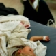 A mother watches over her child who has a severe case of dysentery due to lack of a clean water. Kate Holt.