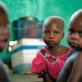 Three young children in a hospital supported by the IRC in Kalemie, Katanga. Kate Holt.