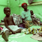 A family sit in their tent in a transit centres for IDP's in Ganta. Kate Holt.