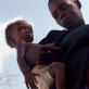 A mother from Cote D'Ivoire with her young child. Having travelled for over three weeks to reach Saclapea camp. Kate Holt.