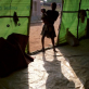 A girl and her young baby stand in the doorway of an IDP settlement in Monrovia. Kate Holt.